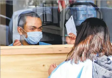  ?? EDUARDO CONTRERAS U-T ?? Maria Espinoza meets with her son, Joshua, who has severe autism, at his group home in El Cajon last week. Joshua used to be able to visit his family for the weekends at their home, but hasn’t been able to because of the pandemic.