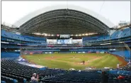  ?? NATHAN DENETTE — THE CANADIAN PRESS VIA AP ?? Photograph­ers cover the game in an empty stadium during fourth-inning intrasquad baseball game action in Toronto, Friday, July 17, 2020.