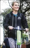  ?? AMANDA VOISARD / AMERICAN-STATESMAN ?? Diana Carey tests out a Lime-S scooter last month in Austin. Two companies, LimeBike and Bird, brought 1,000 scooters to the city that month.