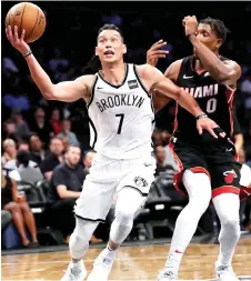  ?? — AFP photo ?? Jeremy Lin (left) of the Brooklyn Nets drives to the basket against Josh Richardson of the Miami Heat in the second half during their Pre Season game at Barclays Centre in the Brooklyn Borough of New York City in this Oct 5, 2017 file photo.