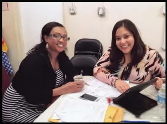  ??  ?? Maria Elena VelascoFon­taine, right, a navigator with the Family Healthcare Foundation, assists a consumer at an Ethiopian church in Tampa, Fla., during the first open enrollment period.