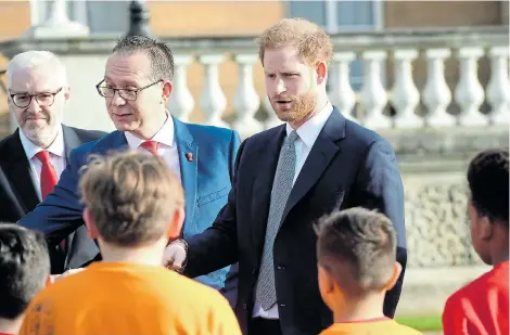  ?? Picture: JEREMY SELWYN/POOL/via REUTERS ?? STEPPING OUT: Prince Harry attends the draw for the Rugby League World Cup where he meets children from a local school who played rugby league in Buckingham Palace gardens yesterday