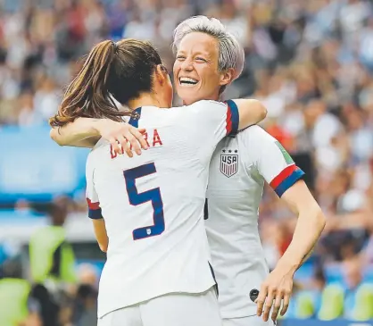  ?? Elsa, Getty Images ?? Megan Rapinoe of the United States celebrates with teammate Kelley O’Hara after scoring her team’s first goal during the Women's World Cup quarterfin­al match on Friday in Paris. The U.S. will play England on Tuesday.