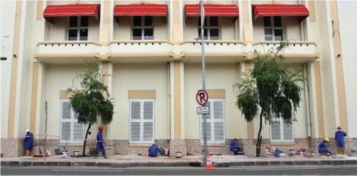  ?? AHMAD KHUSAINI/JAWA POS ?? MAKIN KINCLONG: Pekerja memasang keramik di luar gedung peninggala­n Belanda di Jalan Veteran Nomor 6–8, Krembangan, kemarin.