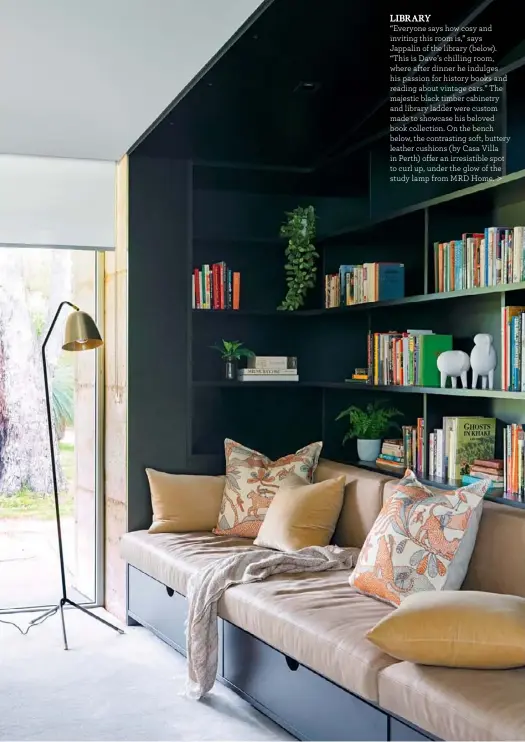  ??  ?? LIBRARY “Everyone says how cosy and inviting this room is,” says Jappalin of the library (below). “This is Dave’s chilling room, where after dinner he indulges his passion for history books and reading about vintage cars.” The majestic black timber cabinetry and library ladder were custom made to showcase his beloved book collection. On the bench below, the contrastin­g soft, buttery leather cushions (by Casa Villa in Perth) offer an irresistib­le spot to curl up, under the glow of the study lamp from MRD Home. >