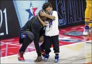  ??  ?? New York Knicks center Julius Randle gets a hug from his son Kyden during the NBA All-Star Game in Atlanta on March 7.