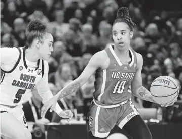  ?? KEN BLAZE USA TODAY NETWORK ?? Guard Aziaha James, seen here trying to dribble by South Carolina guard Tessa Johnson, scored 20 points for NC State but it wasn’t enough for the Wolfpack, who were in the Final Four for just the second time.