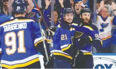  ?? JEFF ROBERSON/AP ?? St. Louis Blues centre Tyler Bozak, centre, celebrates with Vladimir Tarasenko and Ryan O’Reilly after scoring what would turn out to be the game-winning goal against the San Jose Sharks during the first period in Game 4 of the Western Conference final series on Friday in St. Louis.