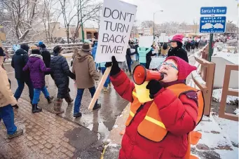  ?? EDDIE MOORE/JOURNAL ?? Morgana Margaine of Santa Fe leads a chant as thousands of protesters make their way to the Roundhouse in Santa Fe on Saturday. The group started at the Bataan Memorial Building, went through the Plaza and ended at the Roundhouse.