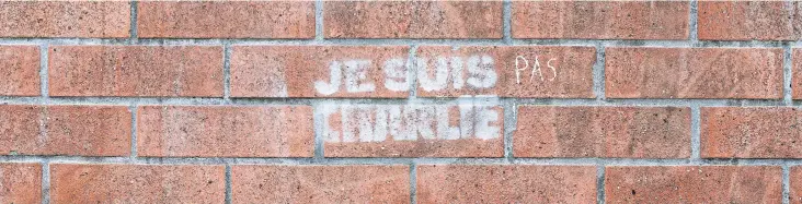  ??  ?? Graffiti on a wall in Paris on Dec 14. The sign reads ‘Je suis pas Charlie’ which translates as ‘I am not Charlie.’