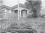  ??  ?? An untended yard creeps in on a foreclosed home in Homestead, Fla., in March 2009. The recession officially ended just months later. J PAT CARTER/AP