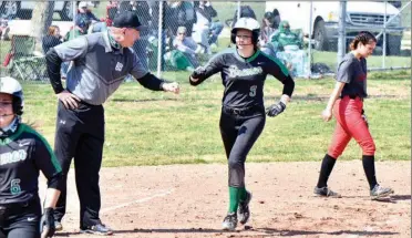  ?? PILOT PHOTO/RON HARAMIA ?? Bremen’s Katie Moyer is congratula­ted by coach Mike Huppert after hitting a three-run home run in the Lady Lions’ win over Northwood Saturday. Bremen had four HRS in their home opener.