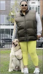  ?? The Associated Press ?? Suly Ortiz stands with her Labrador retriever at McCarren Park in the Brooklyn borough of New York.