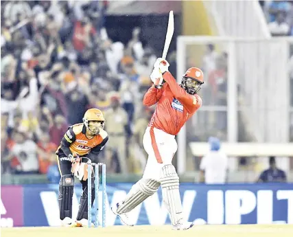  ?? — AFP photo ?? Kings XI Punjab cricketer Chris Gayle plays a shot during the 2018 Indian Premier League (IPL) Twenty20 cricket match between Kings XI Punjab and Sunrisers Hyderabad at The Punjab Cricket Associatio­n Stadium in Mohali on April 19, 2018.