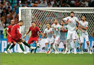  ?? FRANCISCO SECO/THE ASSOCIATED PRESS ?? Portugal’s Cristiano Ronaldo (left) scores the game-tying goal during the Group B match against Spain at Fisht Stadium on Friday in Sochi, Russia. The teams played to a 3-3 draw.
