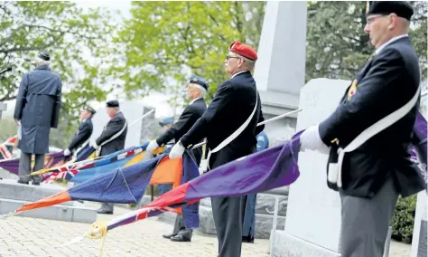  ?? EMILY MOUNTNEY-LESSARD/BELLEVILLE INTELLIGEN­CER ?? The Royal Canadian Legion Branch 99 colour party lowers their flags while taking part in a commemorat­ive service rememberin­g the Battle of Vimy Ridge, the Battle of the Atlantic and Victory in Europe day, in May at the Cenotaph in Belleville, Ont.