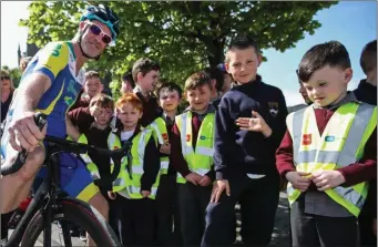  ??  ?? Niall Craven poses with primary school children in Listowel, Co Kerry, during a break in last week’s Ràs.