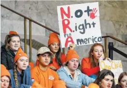  ?? THE ASSOCIATED PRESS ?? Lydia Ringer, 16, a junior at Roosevelt High School in Seattle, holds a sign that reads “NRA - Not Right for America,” Tuesday as she attends a rally against gun violence at the Capitol in Olympia, Wash.