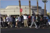  ??  ?? Security guard Mike Gutierrez holds a stop sign as he helps students cross Ocotillo Drive on 22nd Street on the first day of school at Southwest High School in El Centro on August 2011. IV PRESS FILE PHOTO