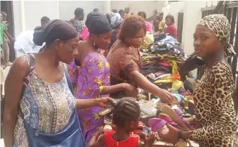  ??  ?? Members of the community picking items of their choice during CCIC’s reach out programme to mark its 30th anniversar­y