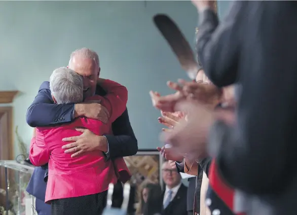  ?? CHAD HIPOLITO/THE CANADIAN PRESS ?? Premier John Horgan hugs deputy premier Carole James after being sworn in with his cabinet at Government House in Victoria on Tuesday.