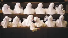  ?? David Goldman / Associated Press ?? Nuns sit in their pews while waiting for the pope at the basilica, the nation’s largest Catholic edifice.