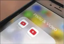  ?? JENNY KANE / ASSOCIATED PRESS ?? A button for the YouTube Kids app (left) on an iPhone. The Google subsidiary says its main YouTube site is for viewers 13 and over, and younger people are sent to YouTube Kids.