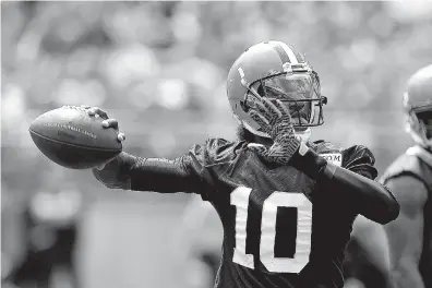  ?? Associated Press ?? Cleveland Browns quarterbac­k Robert Griffin III plays in the Orange and Brown scrimmage Saturday in Columbus, Ohio. Griffin beat out Josh McCown for starting quarterbac­k.