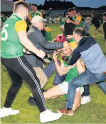  ??  ?? Controvers­y: Fans invading the pitch after the Thomas Clarkes GAA Club won the Tyrone senior football final