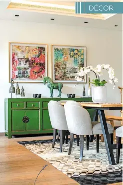  ??  ?? The dining space is anchored with a monochrome rug against the emerald green sideboard