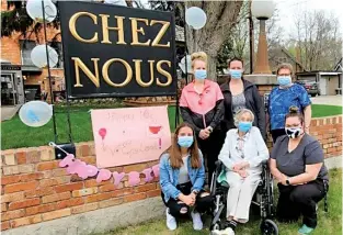  ??  ?? Surrounded by staff from the Chez Nous care home, Violet England (seated centre) celebrates her 106th birthday outside after two months of quarantine inside. Photo courtesy Chez Nous