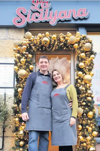  ??  ?? Taste of Italy Laura Raimondi and Steven Dalton outside their festively decorated bistro in Scone