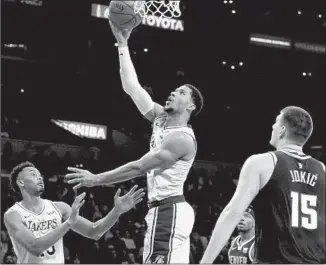  ?? Luis Sinco Los Angeles Times ?? LAKERS GUARD Josh Hart, making his second consecutiv­e start, scores against the Denver Nuggets in the second quarter. Hart finished with 14 points in the Lakers’ 121-114 victory.