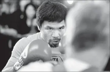  ?? Wally Skalij Los Angeles Times ?? MANNY PACQUIAO works out with trainer Freddie Roach at Wild Card Boxing Club in L.A. Roach says he doesn’t feel that boxing and politics mix well. “I kept telling Manny that it wouldn’t work,” the trainer says.