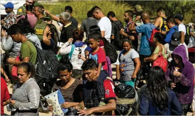  ?? ERIC GAY/THE ASSOCIATED PRESS ?? Migrants wait Oct. 19 to be processed by U.S. Customs and Border Protection at Eagle Pass, Texas, after crossing the Rio Grande from Mexico. A January drop in arrests may reflect several factors that affect the ebb and flow of the numbers. Tougher enforcemen­t by Texas and Mexico against illegal immigratio­n is one.