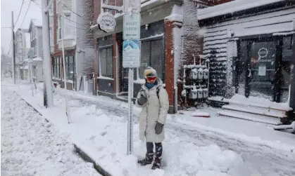  ?? ?? A woman waits for a bus in Portland, Maine, on Thursday. Photograph: Brianna Soukup/AP