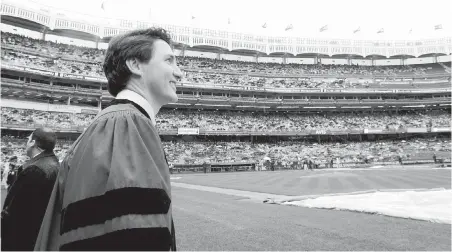  ??  ?? Prime Minister Justin Trudeau takes part in the procession before delivering the commenceme­nt address to New York University graduates at Yankee Stadium in New York on Wednesday.