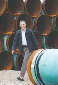  ?? PABLO MARTINEZ MONSIVAIS / THE ASSOCIATED PRESS FILES ?? Then-president Barack Obama tours the TransCanad­a (now TC Energy) Stillwater Pipe Yard in Cushing, Okla.
in 2012. In 2015, he denied access to Keystone XL.