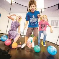  ?? ?? Abby, from left, Mason and Ellie enjoy the trampoline together at the gym.