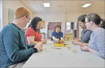  ?? - Ashley Thompson, www.kingscount­ynews.ca ?? Justin Poliquin, Kim O’Connor, Timothy O’Connor, Brent O’Connor and Emma Poliquin test their luck with Camel Up, a relatively new board game that already won a game of the year award.