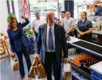  ?? JIM WATSON/AFP VIA GETTY IMAGES ?? President Joe Biden carried take-out food from Taqueria Habaneros with Vice President Kamala Harris to mark Cinco de Mayo. The hospitalit­y sector continued to show strong job growth.