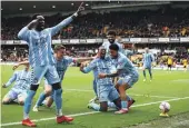  ?? GETTY IMAGES ?? Haji Wright (C) of Coventry City celebrates with teammates after scoring his team’s third goal in their FA Cup quarterfin­al win over Wolves.