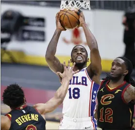  ?? THE ASSOCIATED PRESS ?? Philadelph­ia 76ers’ Shake Milton (18) goes up for a shot between Cleveland Cavaliers’ Taurean Prince (12) and Lamar Stevens (8) during the second half of an NBA basketball game Thursday.