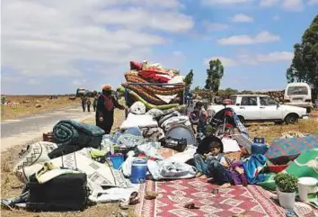  ?? Reuters ?? Internally displaced people from Dara’a province sit with their belongings near the Israeliocc­upied Golan Heights in Quneitra, Syria, on Friday.