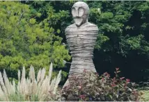  ??  ?? View of the Abbey Gardens and St Edmundsbur­y Cathedral, main; a steel statue on a roundabout near the centre of Bury St Edmund’s which depicts Edmund’s death, above