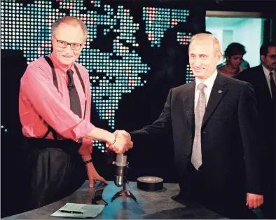  ?? Joshua Roberts / AFP via Getty Images ?? Russian President Vladimir Putin, right, shakes hands with CNN interviewe­r Larry King before the start of his interview in New York in 2000. King died Saturday. He was 87.