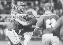  ?? DAVID BEBEE WATERLOO REGION RECORD ?? The Barrie Baycats celebrate winning their fifth straight IBL crown at Jack Couch Park on Thursday.