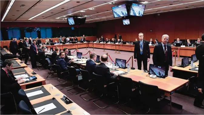  ??  ?? BRUSSELS: Eurogroup finance ministers wait prior to take part in a Eurogroup finance ministers meeting at the European Council in Brussels yesterday. —AFP