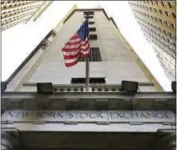  ?? AP PHOTO/ RICHARD DREW ?? In this Friday, Nov. 13, 2015, file photo, the American flag flies above the Wall Street entrance to the New York Stock Exchange.