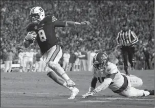  ?? The Associated Press ?? JUST OUT OF REACH: Auburn quarterbac­k Jarrett Stidham (8) gets past Alabama linebacker Dylan Moses (18) to carry the ball in for a touchdown during the second half of the Iron Bowl Saturday in Auburn, Ala.